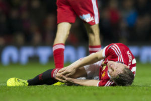 Manchester United's Bastian Schweinsteiger reacts after an injury during the English FA Cup third round soccer match between Manchester United and Sheffield United at Old Trafford Stadium, Manchester, England, Saturday Jan. 9, 2016. (AP Photo/Jon Super)