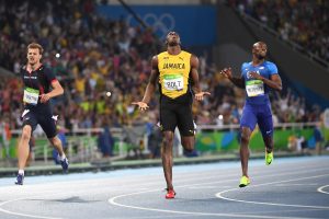 Jamaica's Usain Bolt (C) celebrates as he crosses the finish line to win the Men's 200m Final during the athletics event at the Rio 2016 Olympic Games at the Olympic Stadium in Rio de Janeiro on August 18, 2016.   / AFP / OLIVIER MORIN        (Photo credit should read OLIVIER MORIN/AFP/Getty Images)